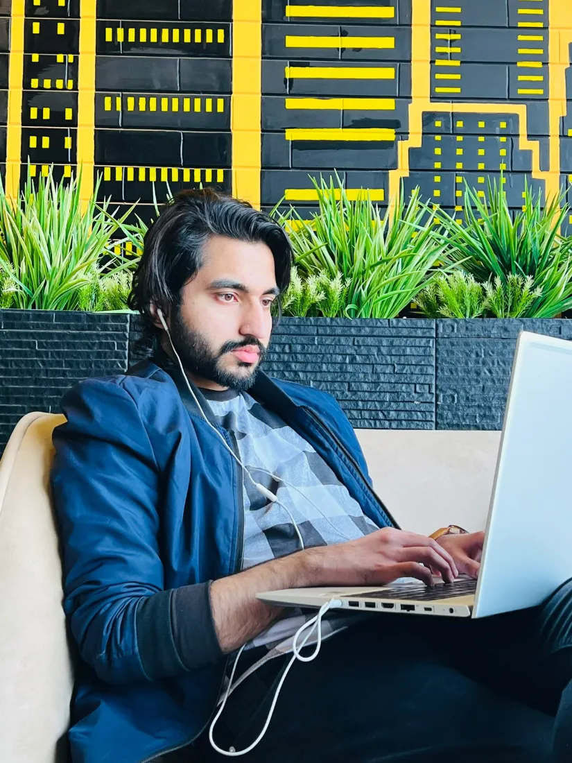 Rizwan working on a laptop